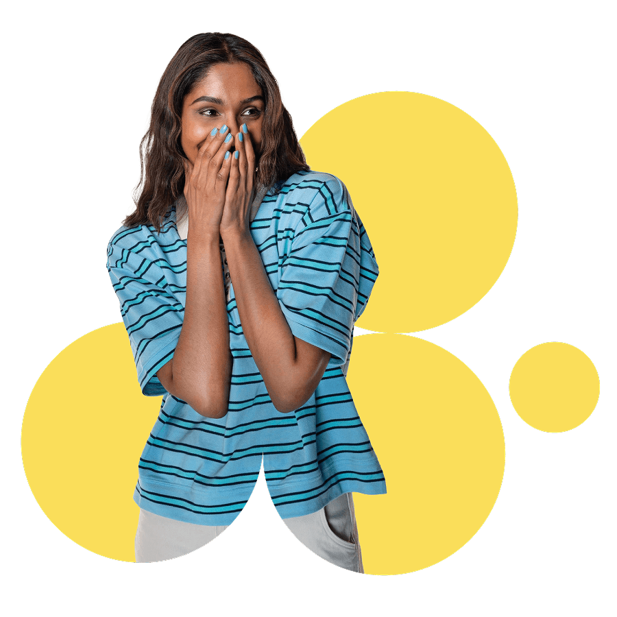 A girl smiling with her hands covering her mouth